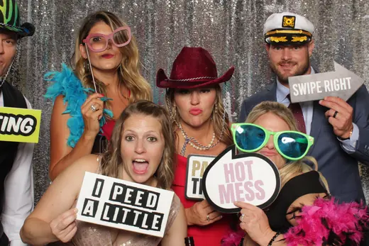 A group in oversized novelty sunglasses with an inflatable sledgehammer