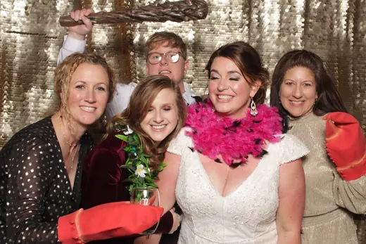 A bride swinging an inflatable sledgehammer while guests duck out of the way